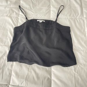 A black light tank top with ruffles at the bottom